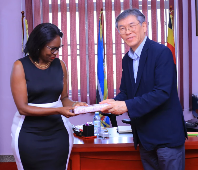 Prof. Pauline Byakika-Kibwika receiving a gift from Prof. Chang-Kee Hyun