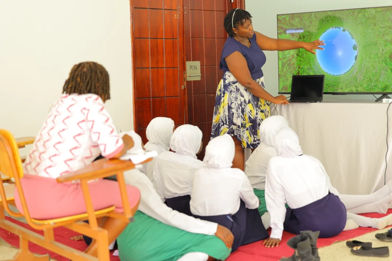 Dr Priscilla demonstrating the apparent motion of the Sun