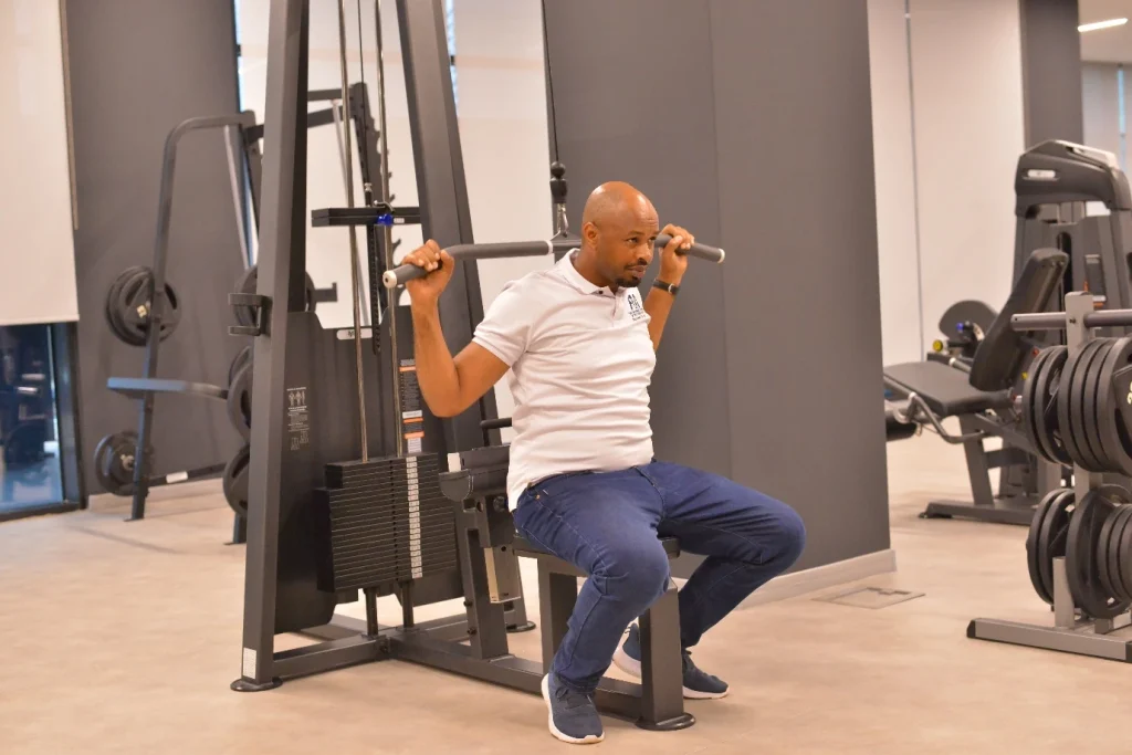 University secretary Mr. Vincent Kansiime Kwatampora trying out the gym