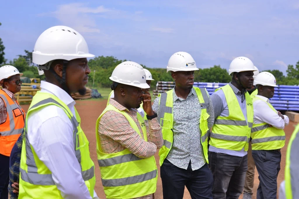 Team at Kaemene I with the key oil field and well pad location within the Tilenga project in Buliisa District