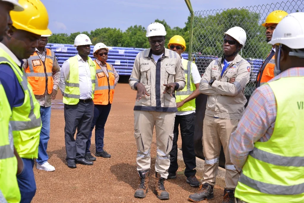 Team at Kaemene I with the key oil field and well pad location within the Tilenga project in Buliisa District